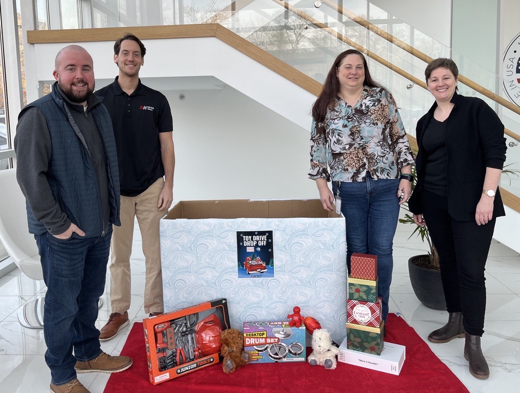 MetroWall team with holiday toy drive donations for Help USA and VVA Spaces.