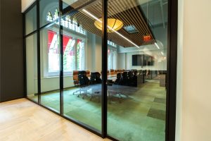 Aluminum glass wall frames with matte black powder coating finish.