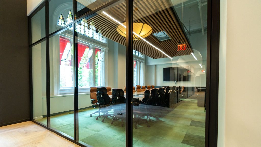 Aluminum glass wall frames with matte black powder coating finish.