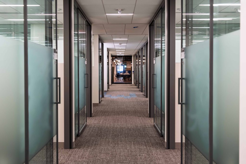 Slimline sliding doors open in offices.